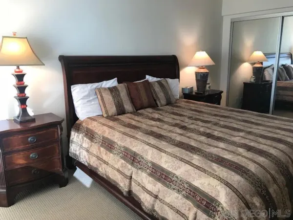 a bed room with a bed and a lamp