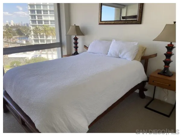 a bed sitting in a bedroom next to a window