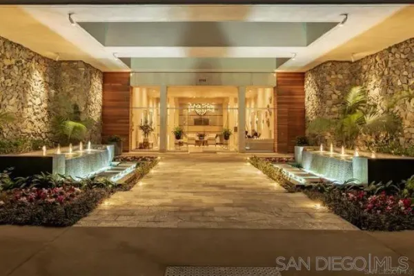 a view of a lobby with a floor to ceiling window and a potted plant