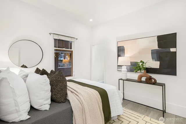 a bedroom with bed and a flat screen tv