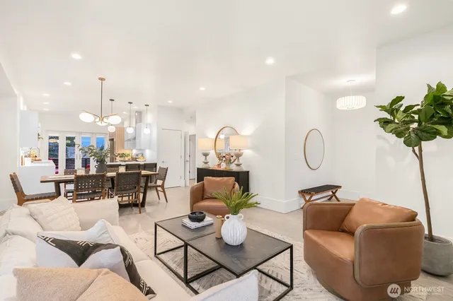 a living room with furniture a rug and white walls