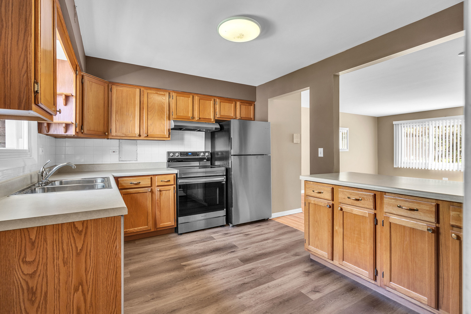 7952 Madison Street, Unit 2E River Forest, IL 60305 - Photo 11 of 25 a kitchen with granite countertop a sink stainless steel appliances and cabinets