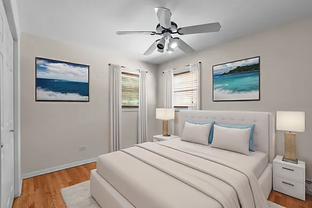 a bedroom with a large bed and a chandelier