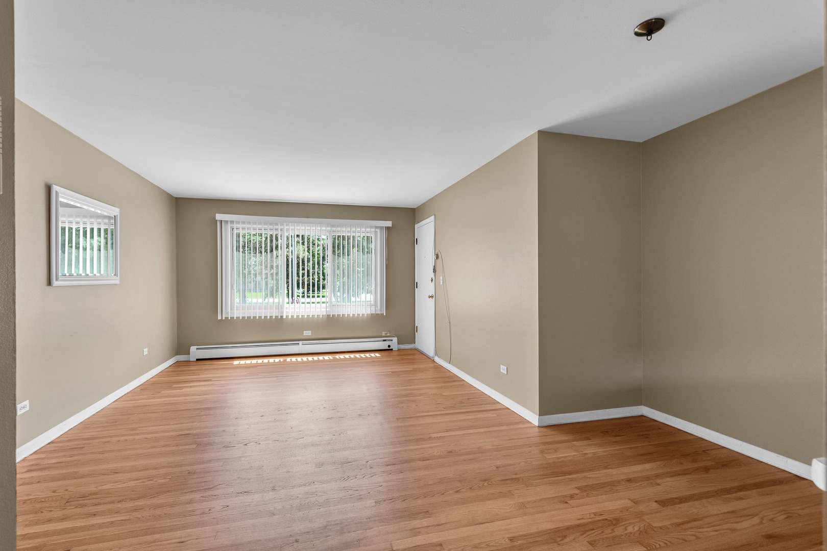 7952 Madison Street, Unit 2E River Forest, IL 60305 - Photo 5 of 25 an empty room with wooden floor and windows