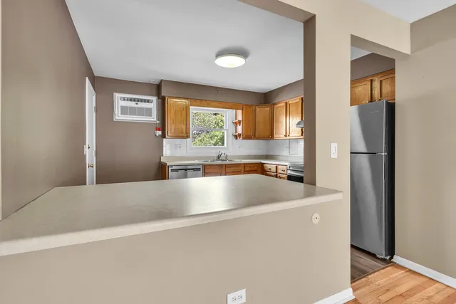 a view of a kitchen with a sink and a refrigerator
