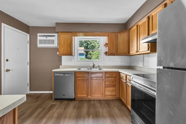 a kitchen with sink window and cabinets