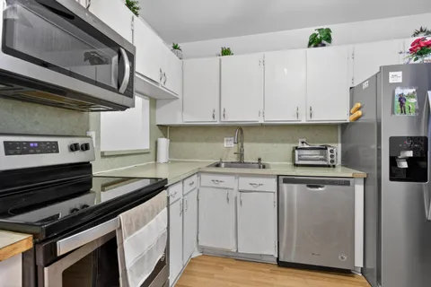 a kitchen with stainless steel appliances granite countertop a stove and a sink