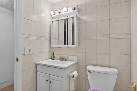 a bathroom with a sink a toilet and mirror