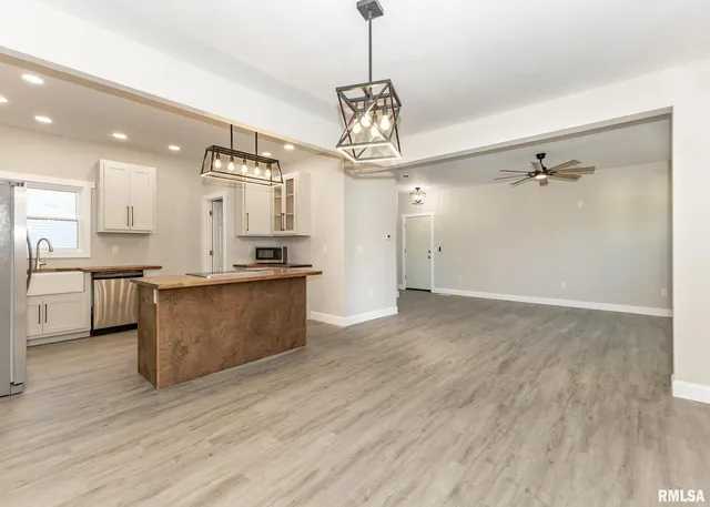 a kitchen with stainless steel appliances granite countertop a sink a refrigerator and a stove