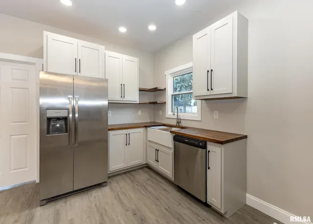 a kitchen with stainless steel appliances granite countertop a stove and a sink