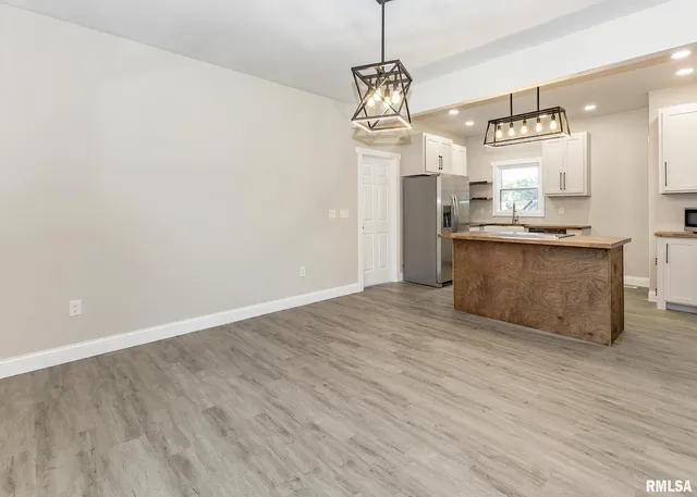 a view of a kitchen with a sink stainless steel appliances and cabinets