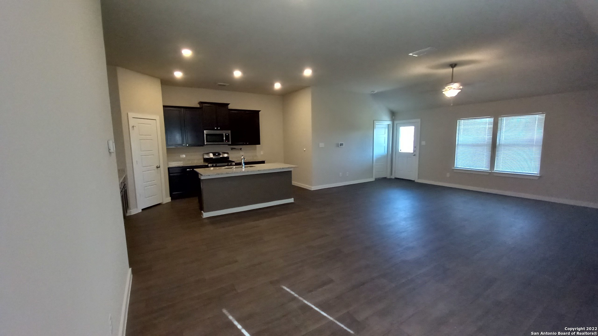 10571 Pablo Way Converse, TX 78109 - Photo 12 of 48 an empty room with wooden floor and windows