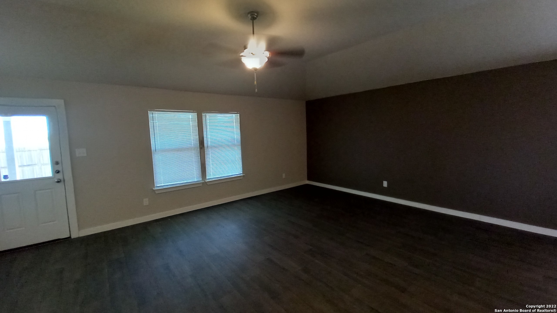 10571 Pablo Way Converse, TX 78109 - Photo 14 of 48 a view of an empty room with wooden floor and a window