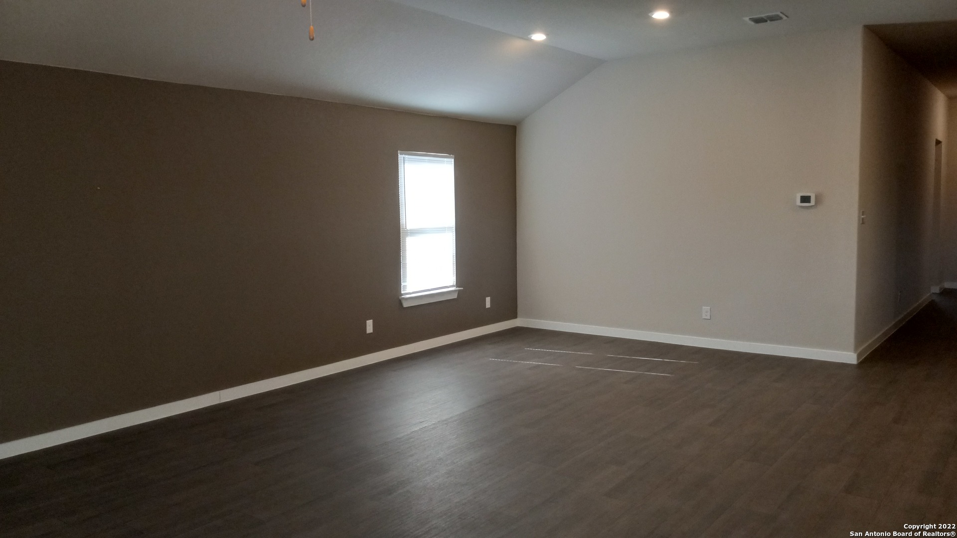 10571 Pablo Way Converse, TX 78109 - Photo 19 of 48 an empty room with wooden floor and windows