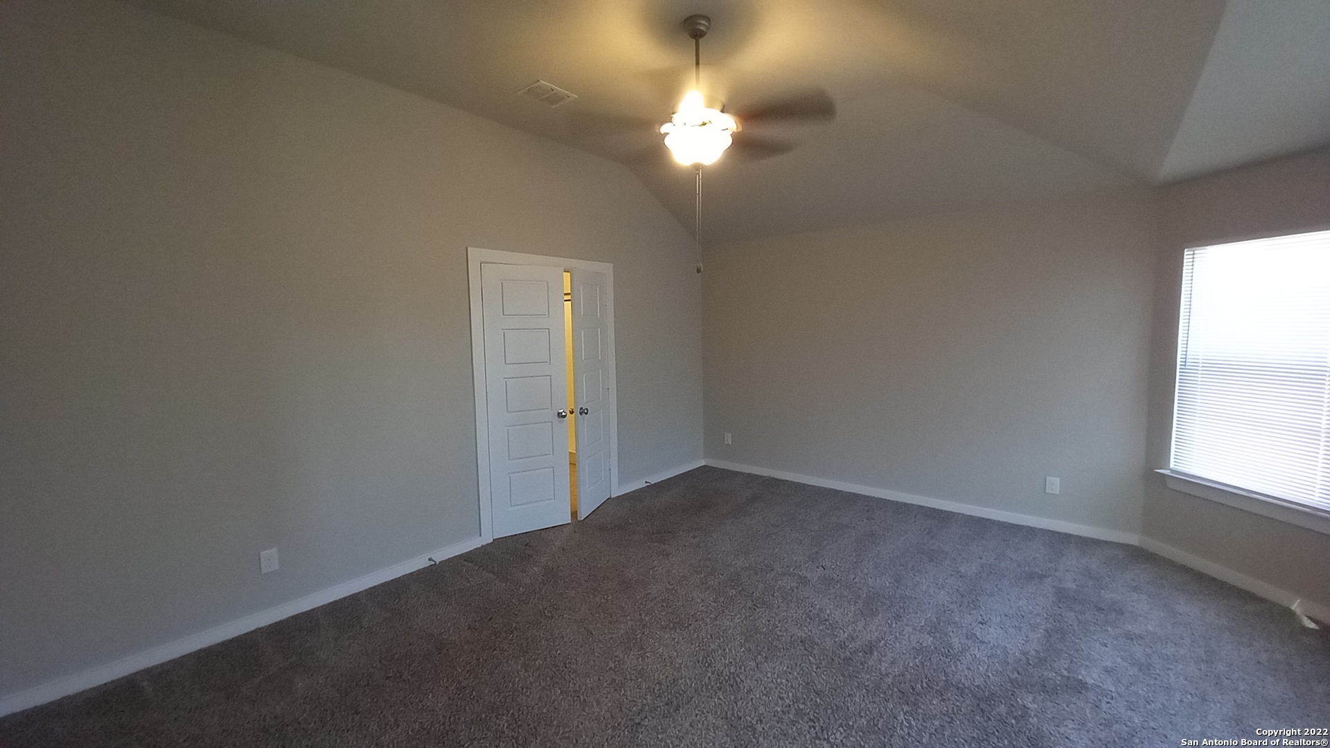 10571 Pablo Way Converse, TX 78109 - Photo 24 of 48 an empty room with a chandelier fan and windows