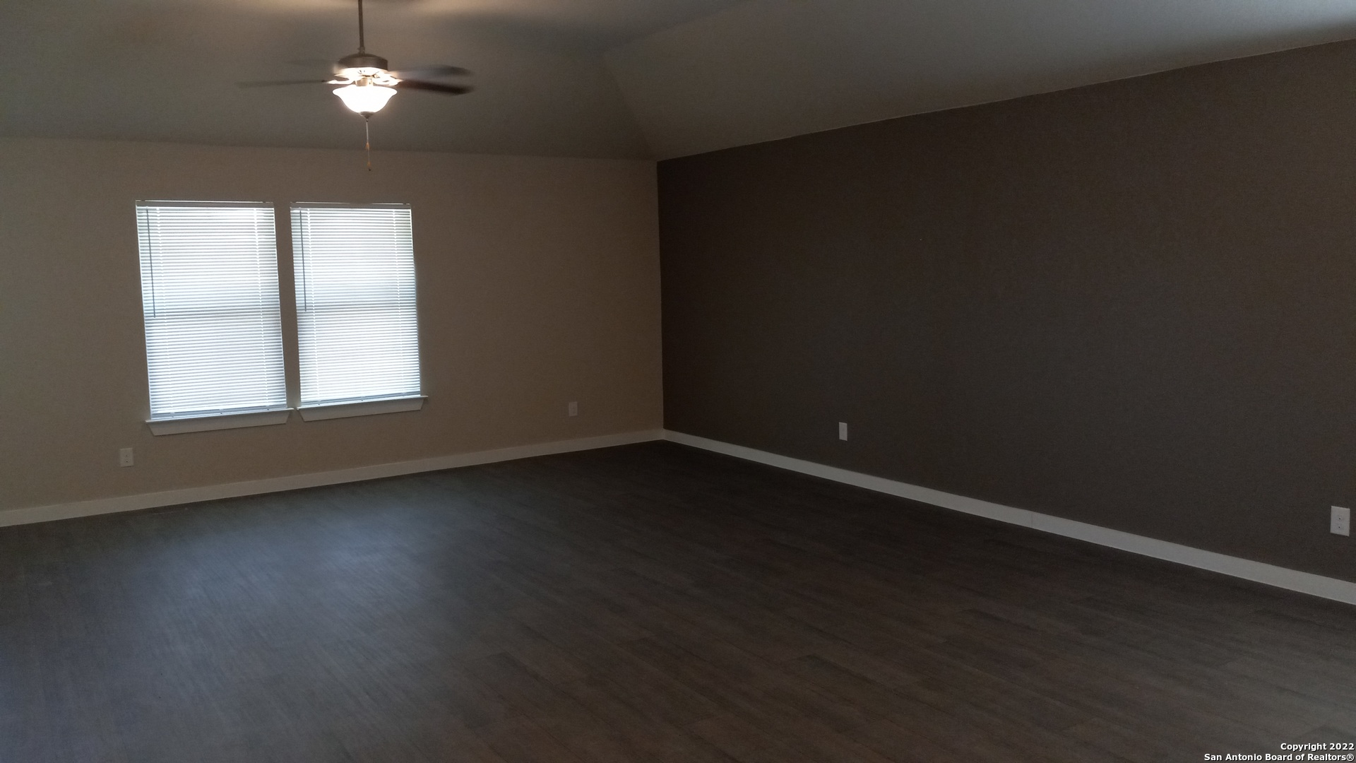 10571 Pablo Way Converse, TX 78109 - Photo 8 of 48 a view of an empty room with wooden floor and a window