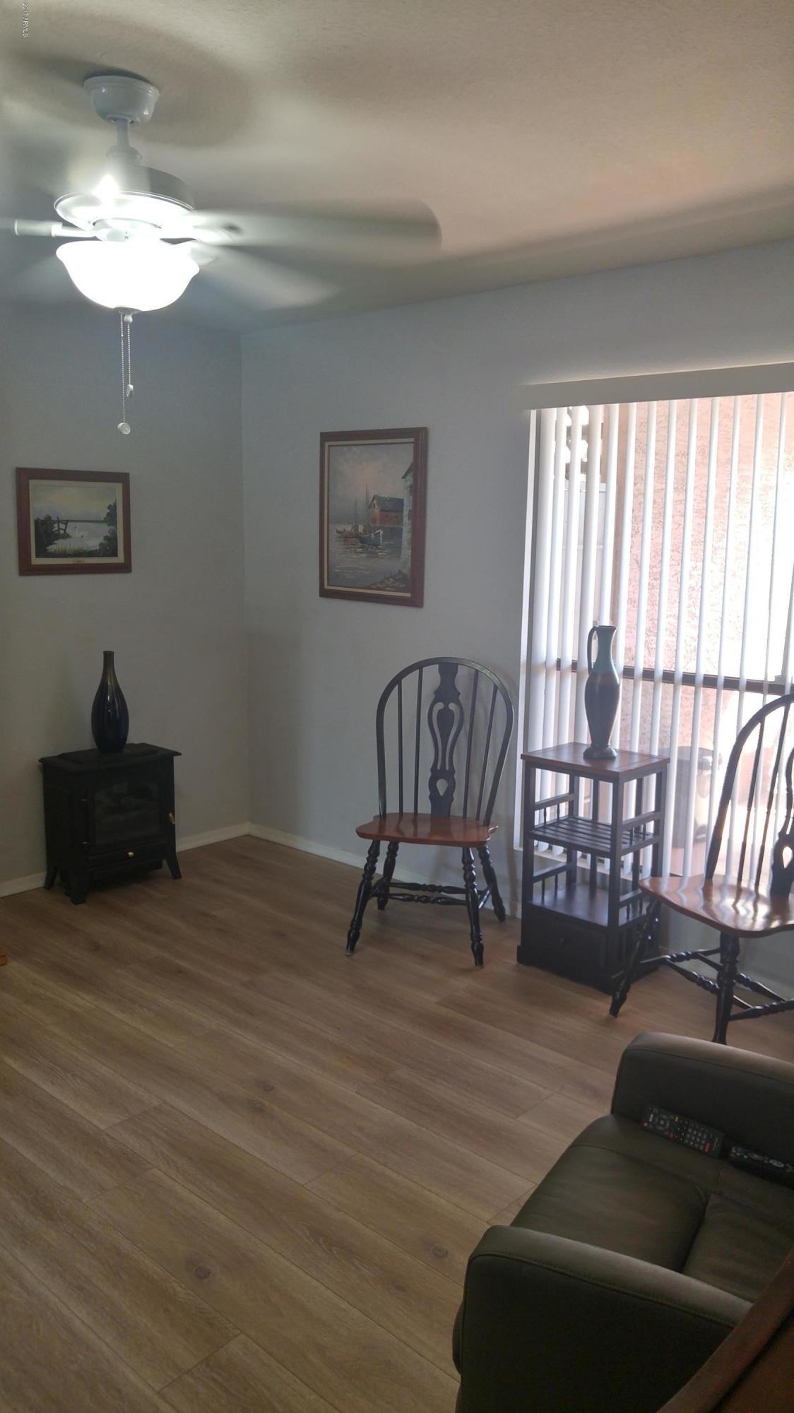 1340 North Recker Road, Unit 219 Mesa, AZ 85205 - Photo 11 of 41 a living room with furniture and a window