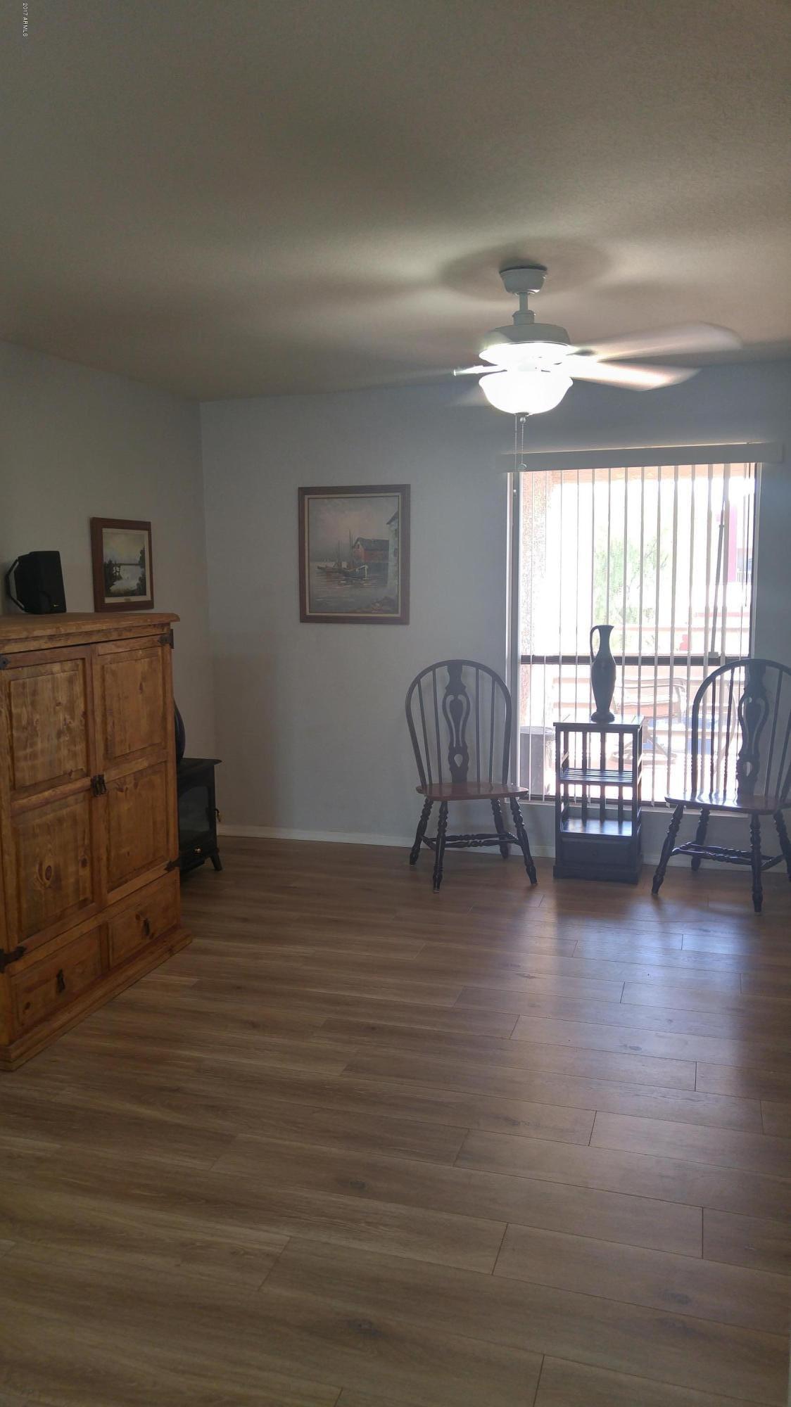 1340 North Recker Road, Unit 219 Mesa, AZ 85205 - Photo 13 of 41 a view of a livingroom with furniture and a window