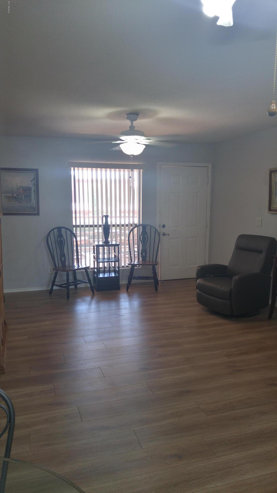 1340 North Recker Road, Unit 219 Mesa, AZ 85205 - Photo 14 of 41 a view of livingroom and hardwood floor