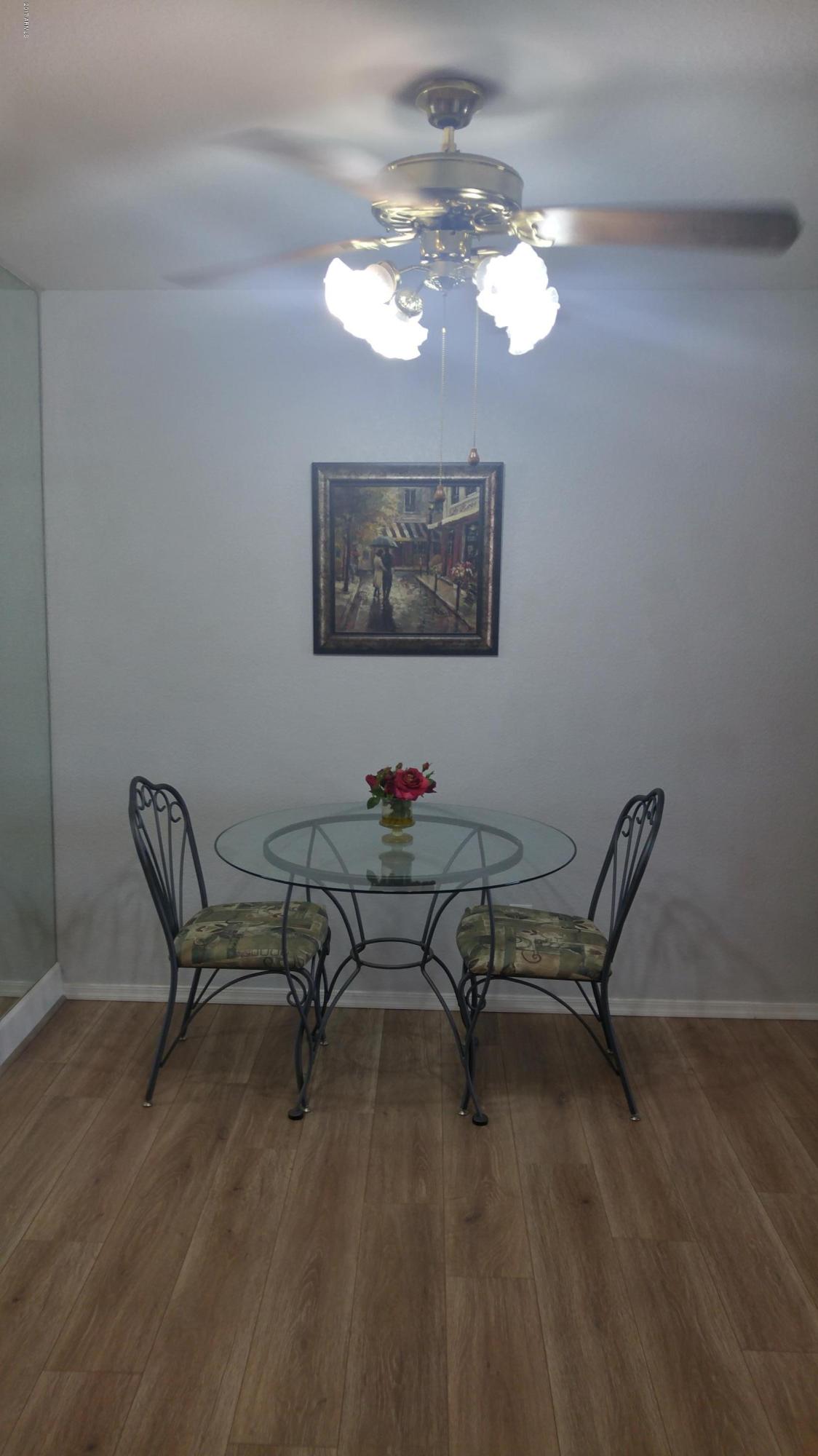 1340 North Recker Road, Unit 219 Mesa, AZ 85205 - Photo 15 of 41 a view of a workspace with furniture and chandelier