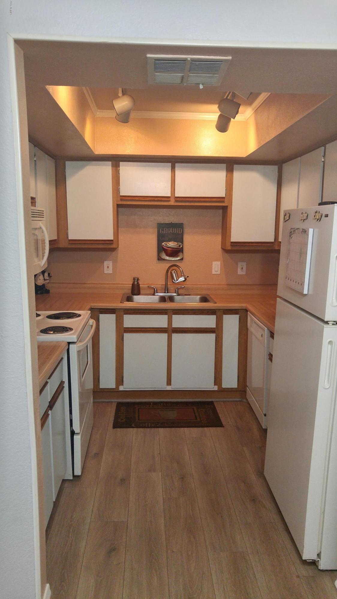 1340 North Recker Road, Unit 219 Mesa, AZ 85205 - Photo 18 of 41 a kitchen with a sink and cabinets