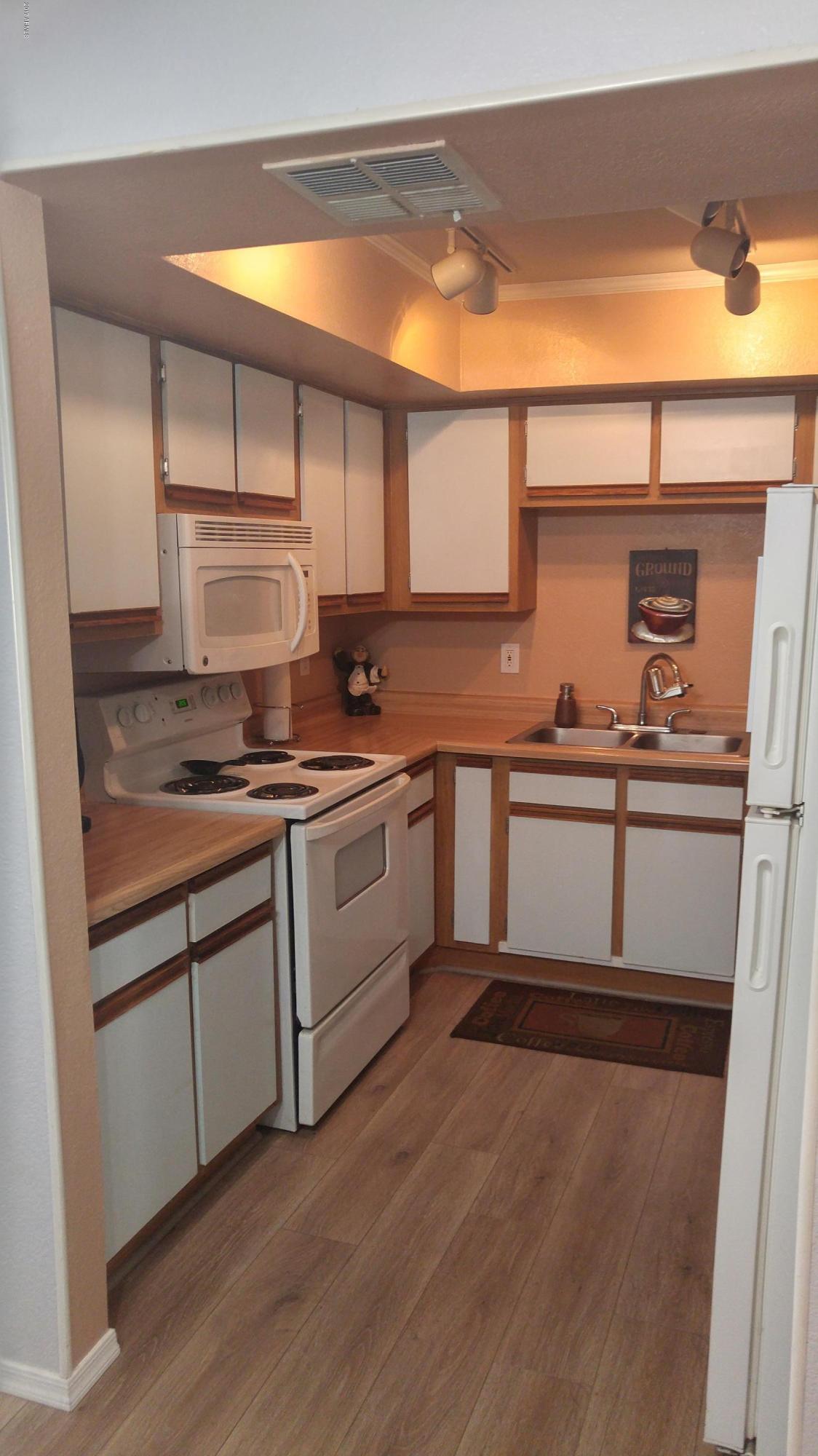 1340 North Recker Road, Unit 219 Mesa, AZ 85205 - Photo 19 of 41 a kitchen with a sink cabinets and appliances