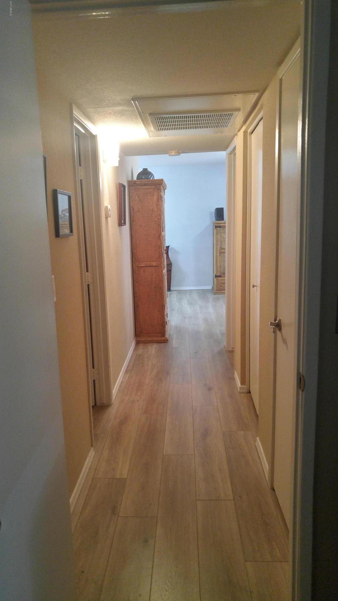 1340 North Recker Road, Unit 219 Mesa, AZ 85205 - Photo 21 of 41 a view of hallway with a large window