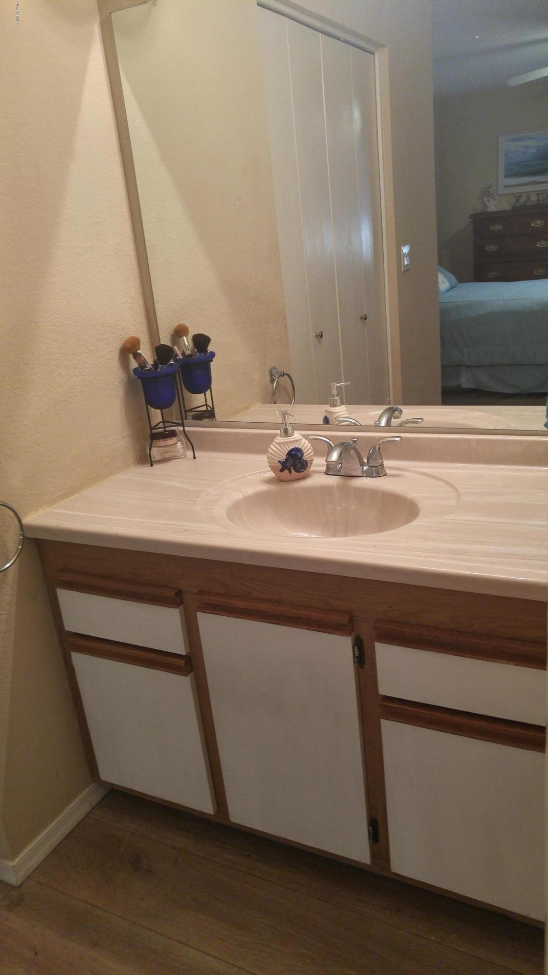 1340 North Recker Road, Unit 219 Mesa, AZ 85205 - Photo 28 of 41 a bathroom with a sink and a mirror