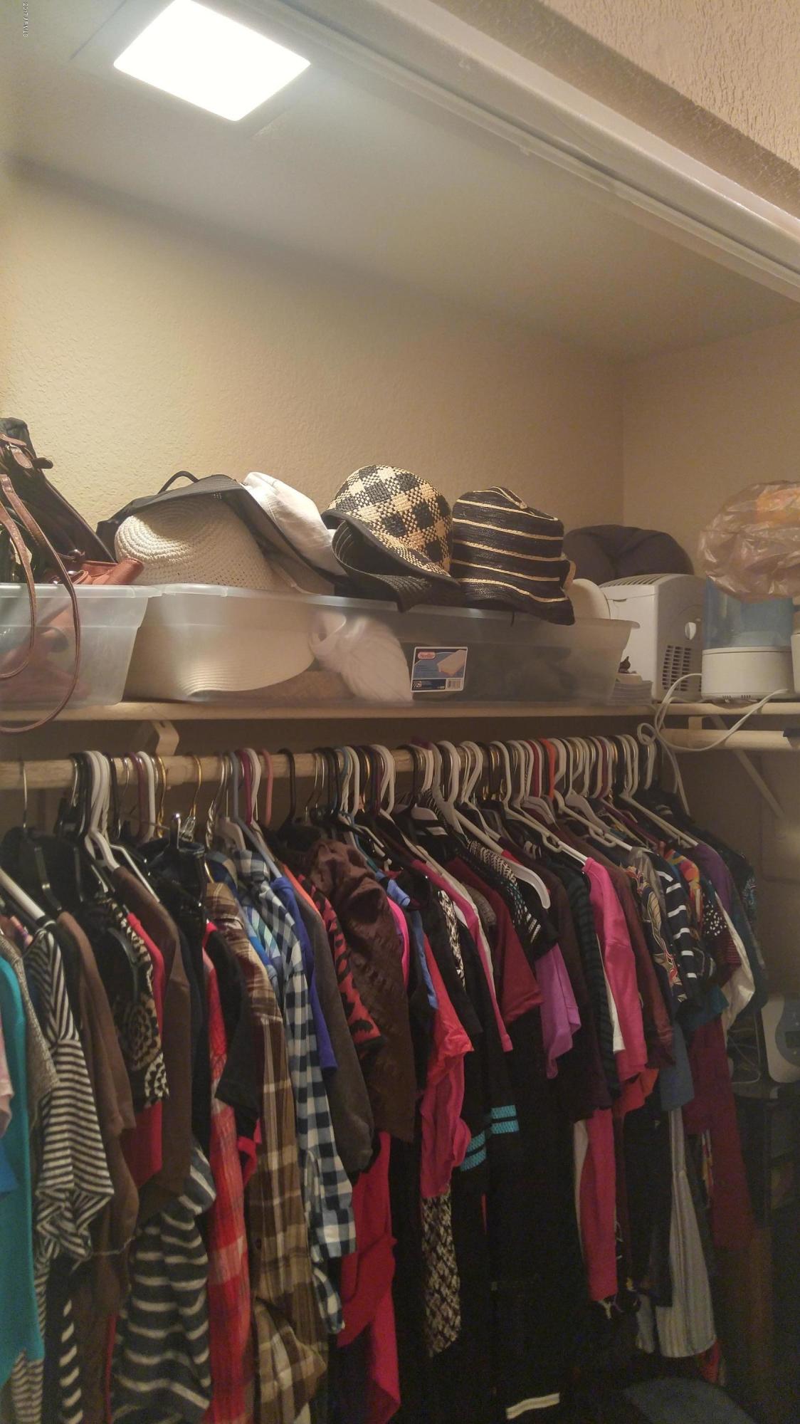1340 North Recker Road, Unit 219 Mesa, AZ 85205 - Photo 31 of 41 a view of walk in closet with clothes and shoes