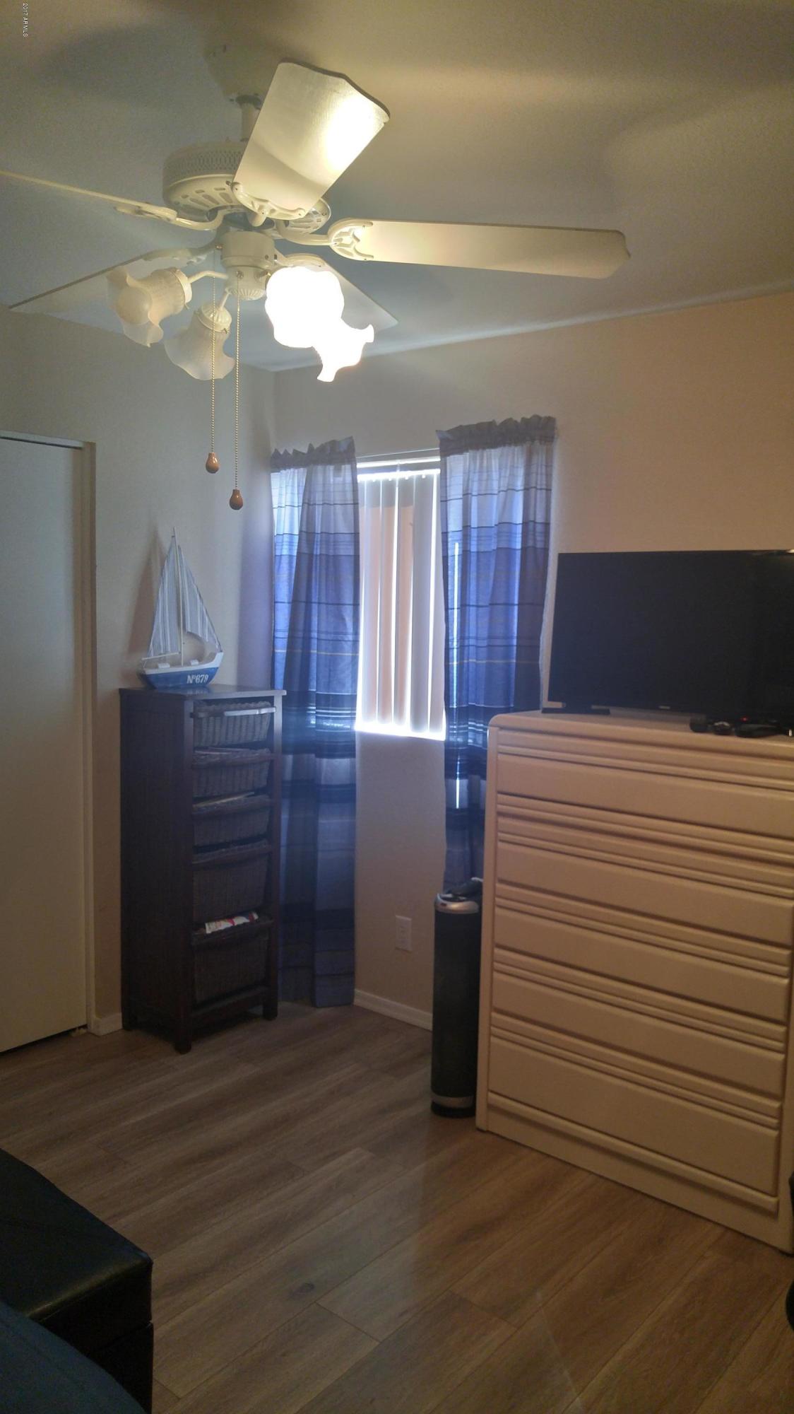 1340 North Recker Road, Unit 219 Mesa, AZ 85205 - Photo 34 of 41 a room with a dresser and a mirror