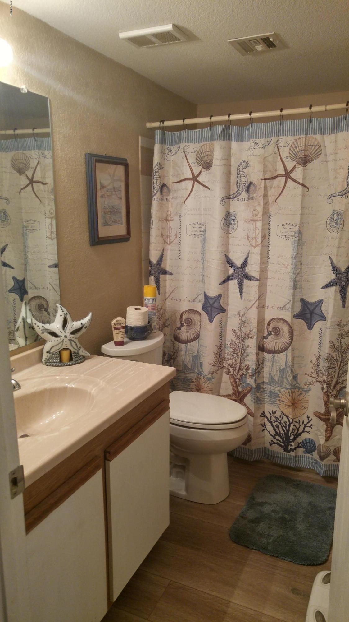 1340 North Recker Road, Unit 219 Mesa, AZ 85205 - Photo 37 of 41 a bathroom with a sink toilet and shower