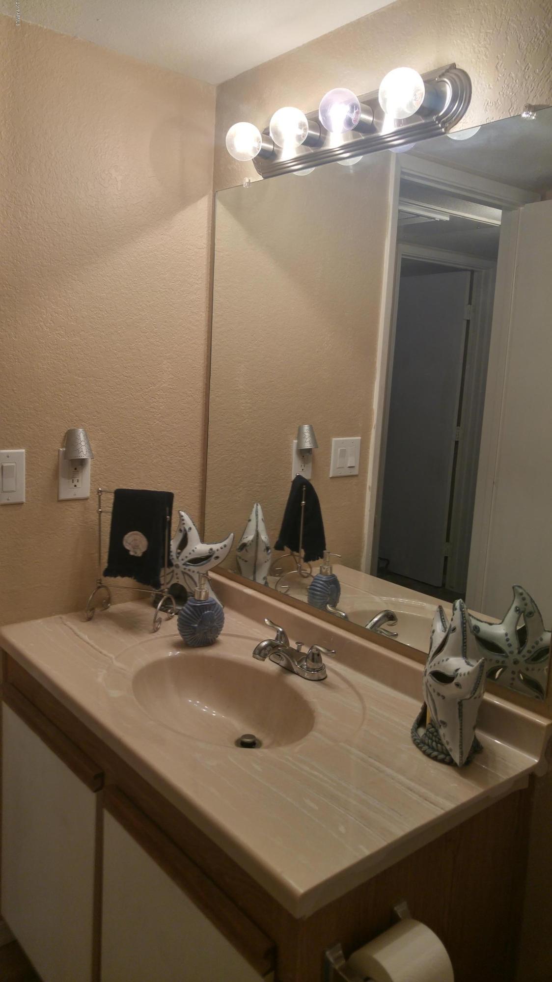 1340 North Recker Road, Unit 219 Mesa, AZ 85205 - Photo 38 of 41 a bathroom with a sink and a mirror