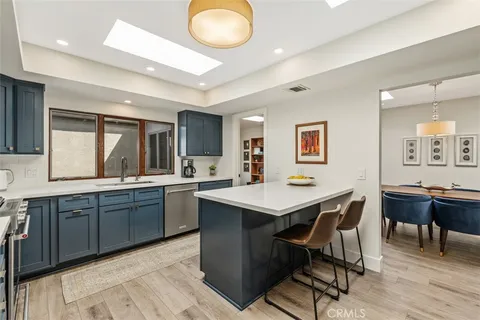 a kitchen with a sink cabinets and wooden floor