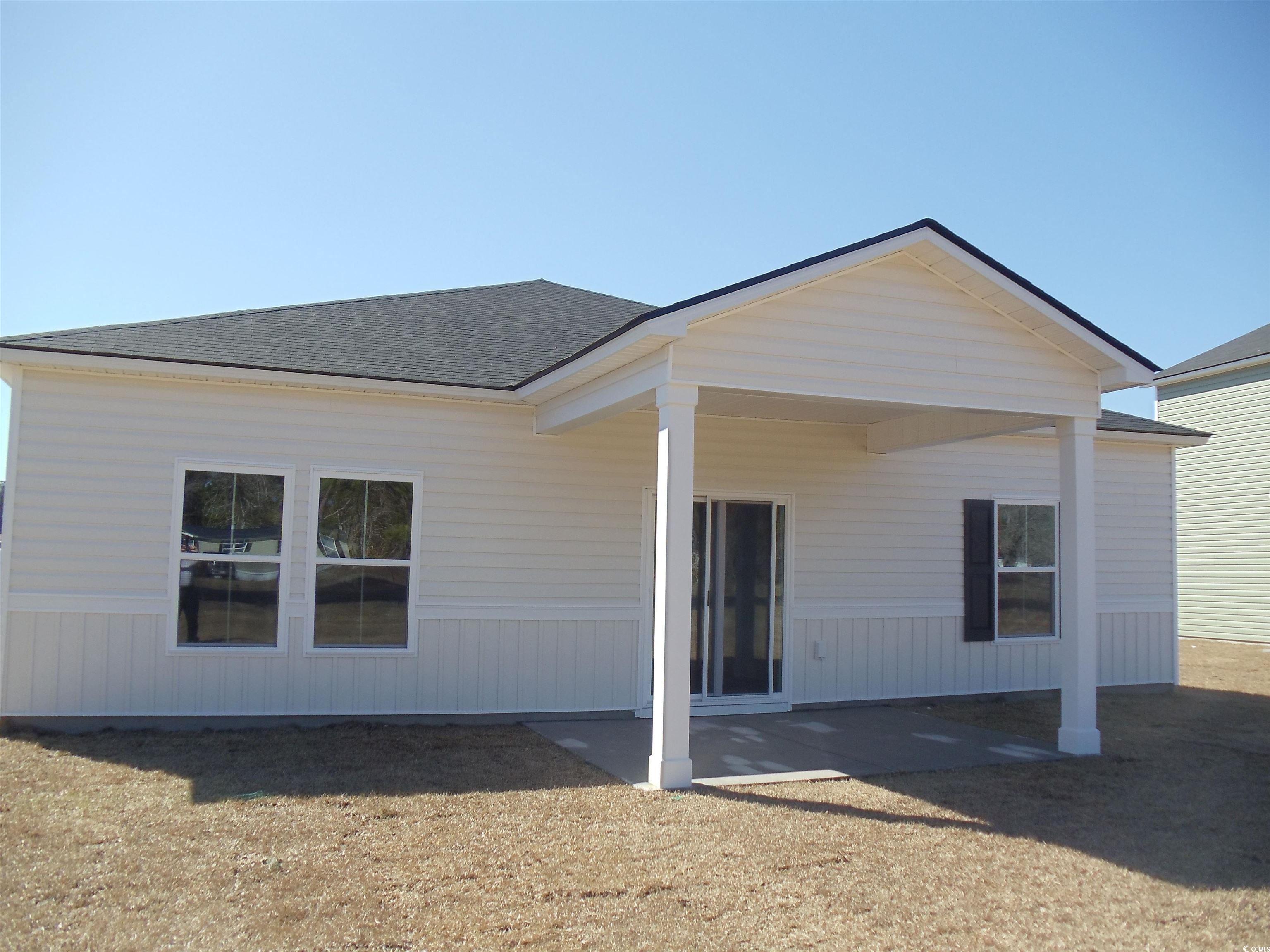 260 Warner Crossing Way Loris, SC 29569 - Photo 3 of 21 Back of property featuring a shingled roof and a patio