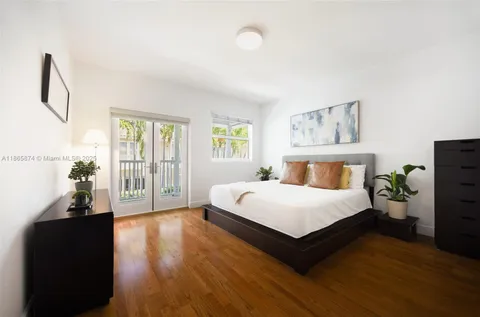 a spacious bedroom with a bed and a large window