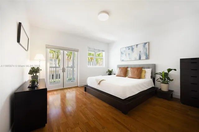 a spacious bedroom with a bed and a large window