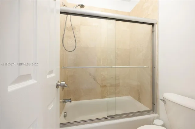a bathroom with a glass shower door