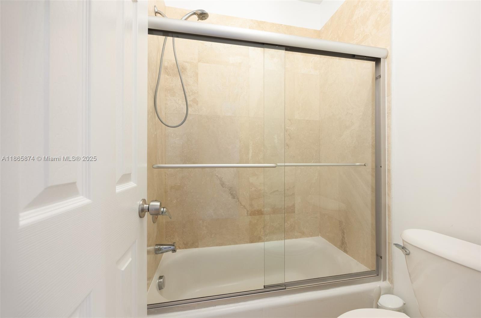 3109 Hibiscus Street, Unit 3109 Coconut Grove, FL 33133 - Photo 17 of 25 a bathroom with a glass shower door