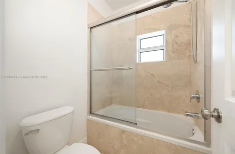 a white bath tub sitting next to a toilet