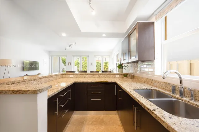 a kitchen with a sink stove and cabinets