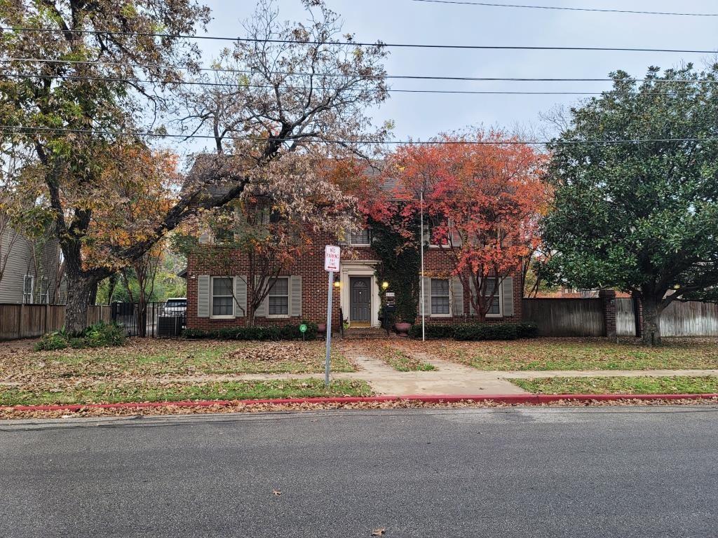 a house that has a tree in front of it