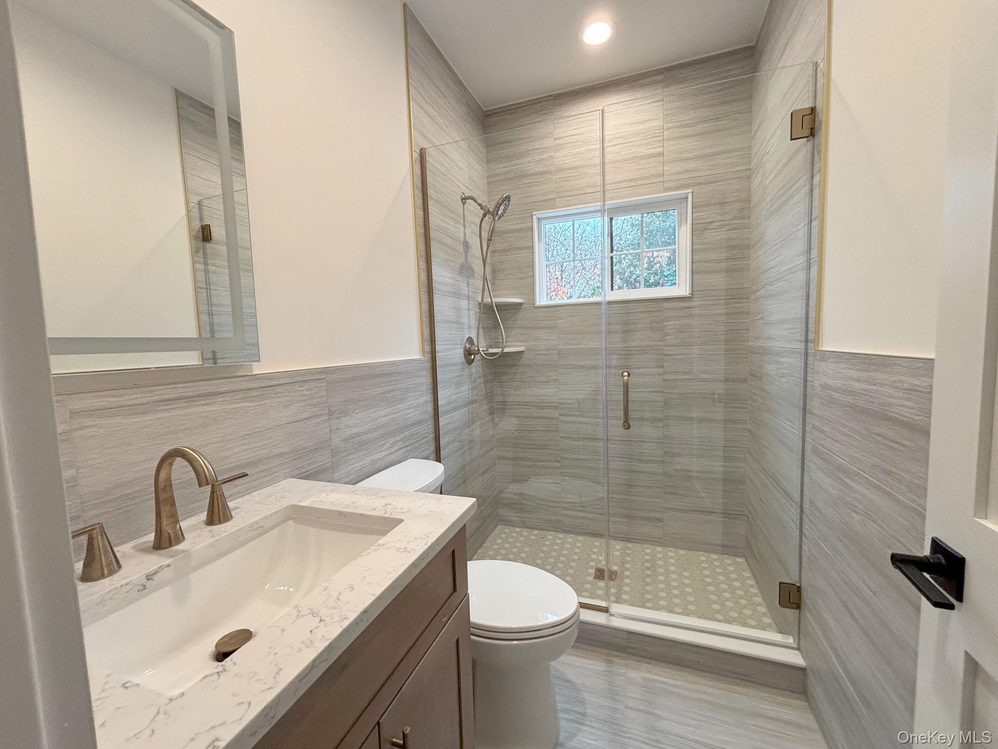 1750 Henry Road Merrick, NY 11566 - Photo 14 of 14 a bathroom with a sink toilet and shower