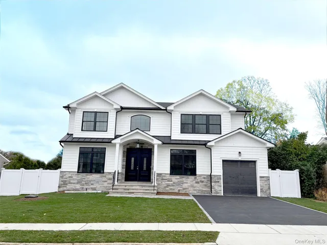 a view of house with yard and outdoor seating