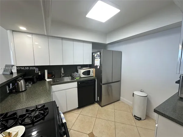 a kitchen with a sink and a stove top oven