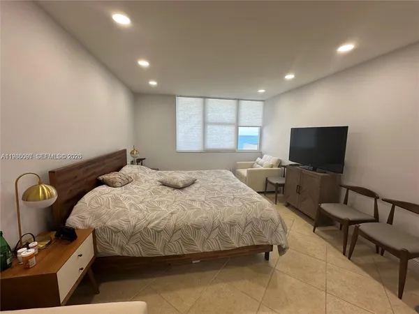 a bedroom with bed and tv