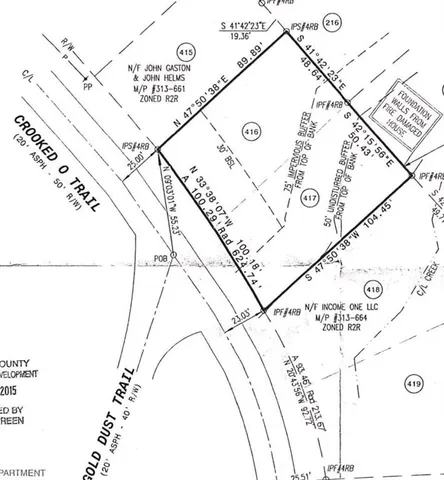 a view of a forest with trees in the background