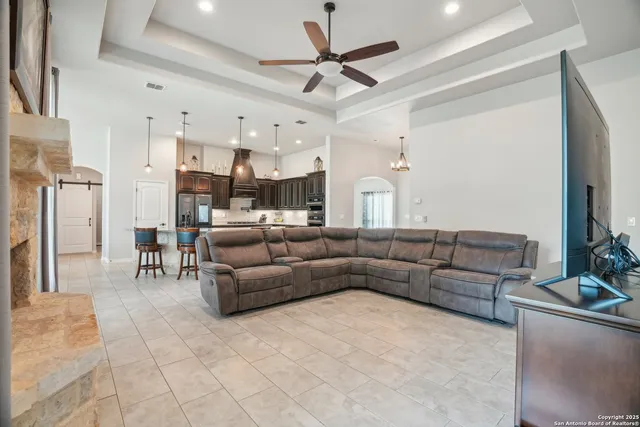 a kitchen with kitchen island a dining table chairs stainless steel appliances and cabinets