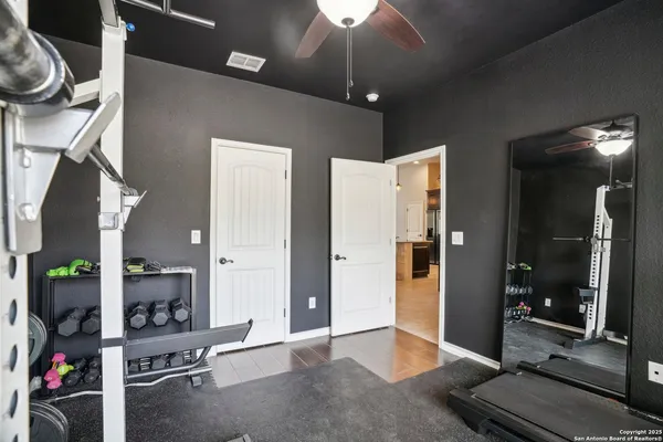 a bedroom with furniture and a flat screen tv