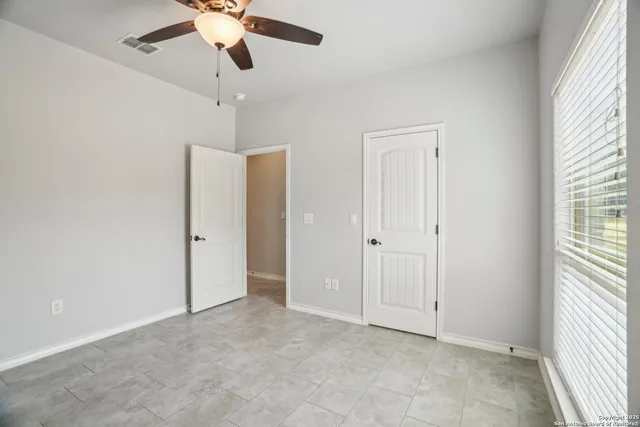 a bedroom with a bed and a television