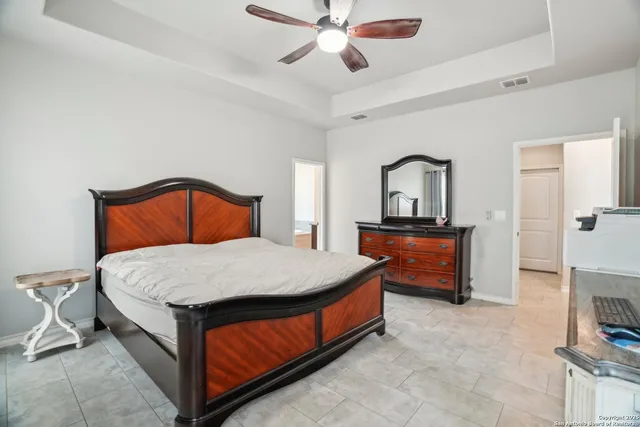 a view of a house with a big yard and large tree